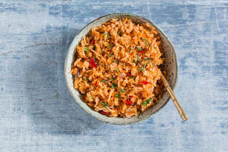 overhead view of easy jollof rice recipe in a bowl with spoon inside