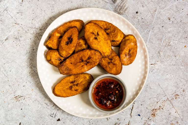 fried plantains on a plate with chutney