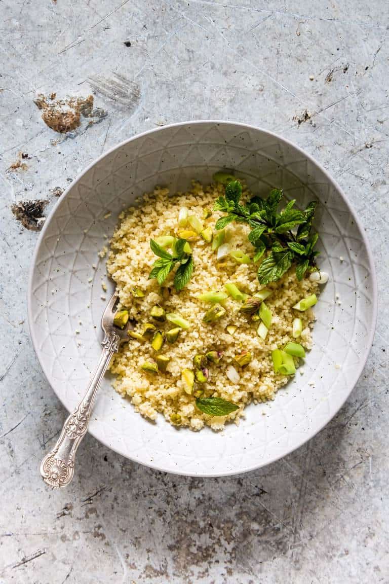 overhead view of how to cook couscous in a bowl with spoon