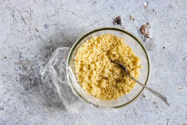 how to cook couscous in a clear bowl with spoon inside and wrap partially off the side