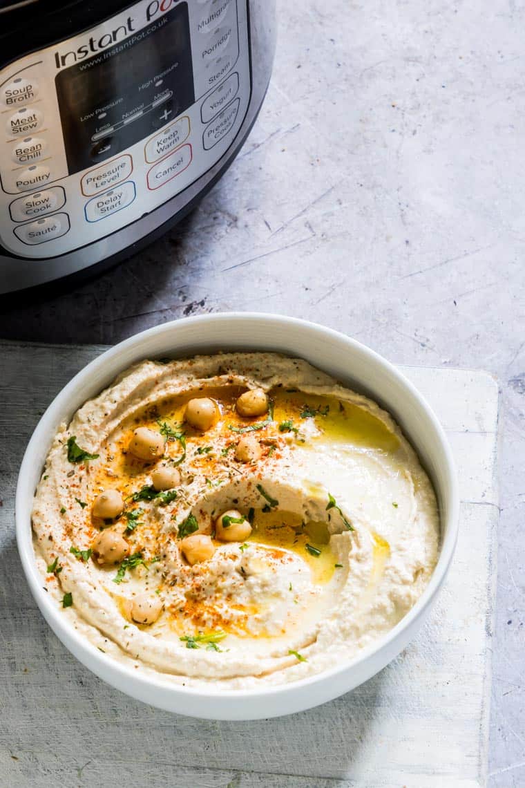 bowl of classic hummus next to an instant pot