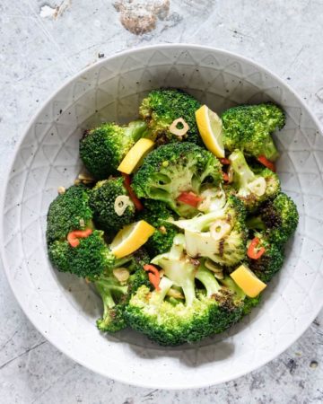 grilled Broccoli in a bowl seasoned with garlic and chilli and lemon