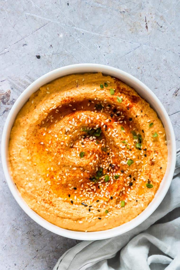 close up of instant pot pumpkin hummus with sesame seeds toppings