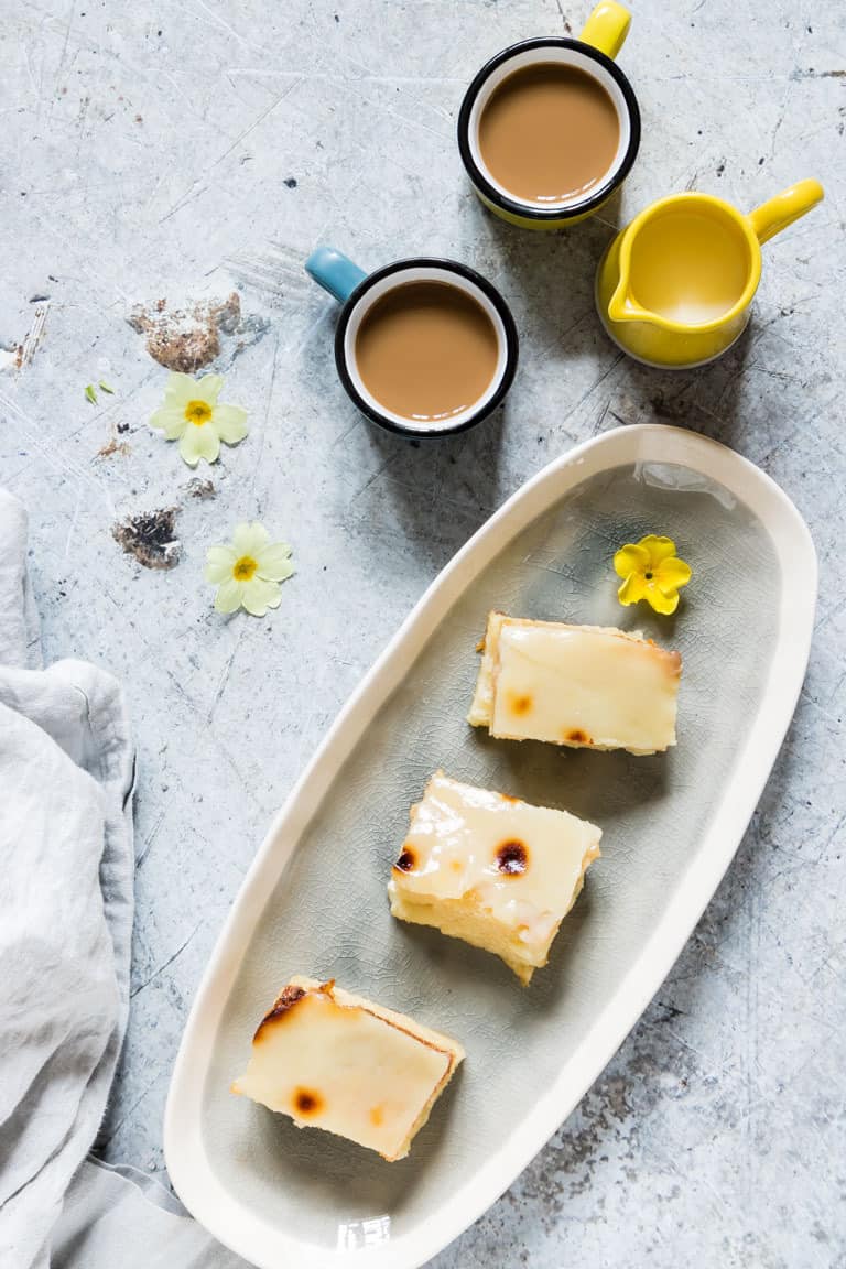 3 slices of filipino cassava cake on a plate with tea and flowers