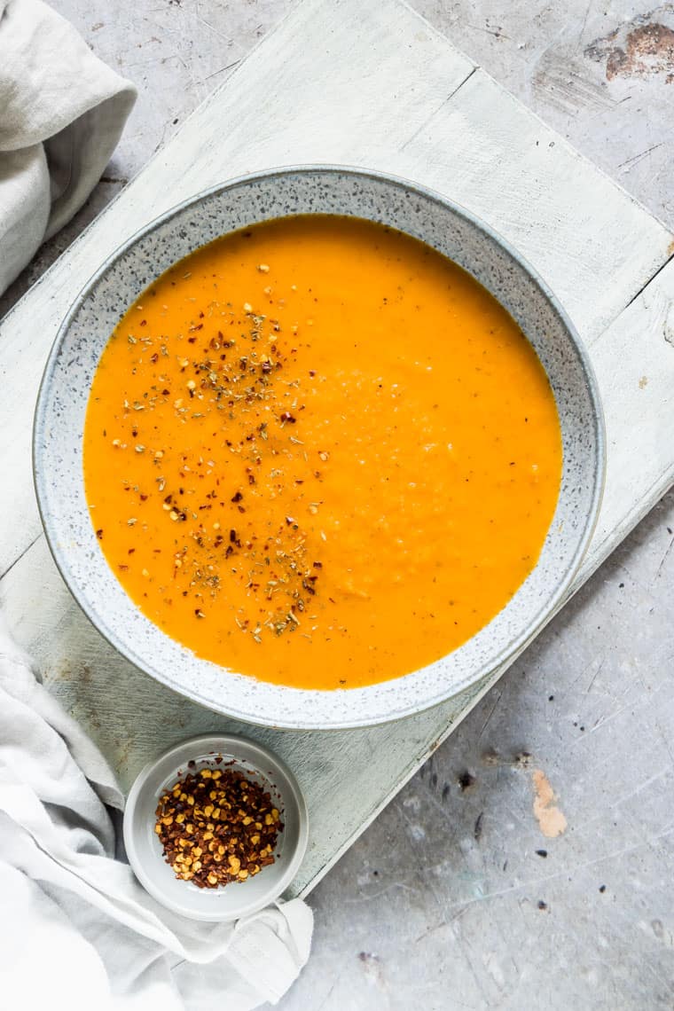 a bowl of curried carrot soup close up
