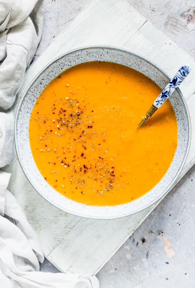 close up of instant pot carrot soup with a spoon