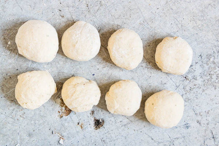 8 pieces of easy italian pizza dough  on a grey surface