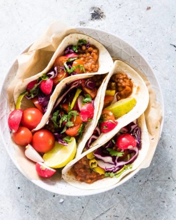 4 easy vegan tacos in a bowl with various toppings