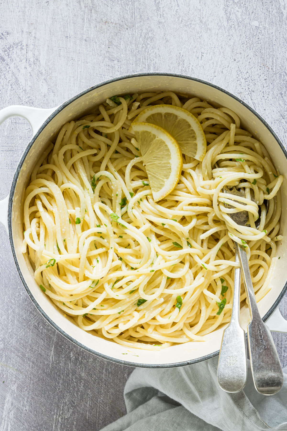lemon pasta in a saucepan with cutlery