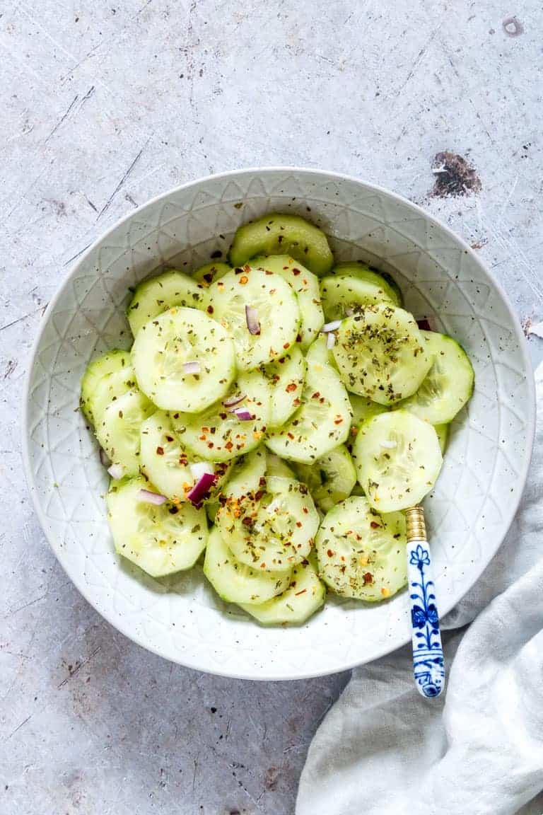 cucumber salad recipe in a bowl with a spoon