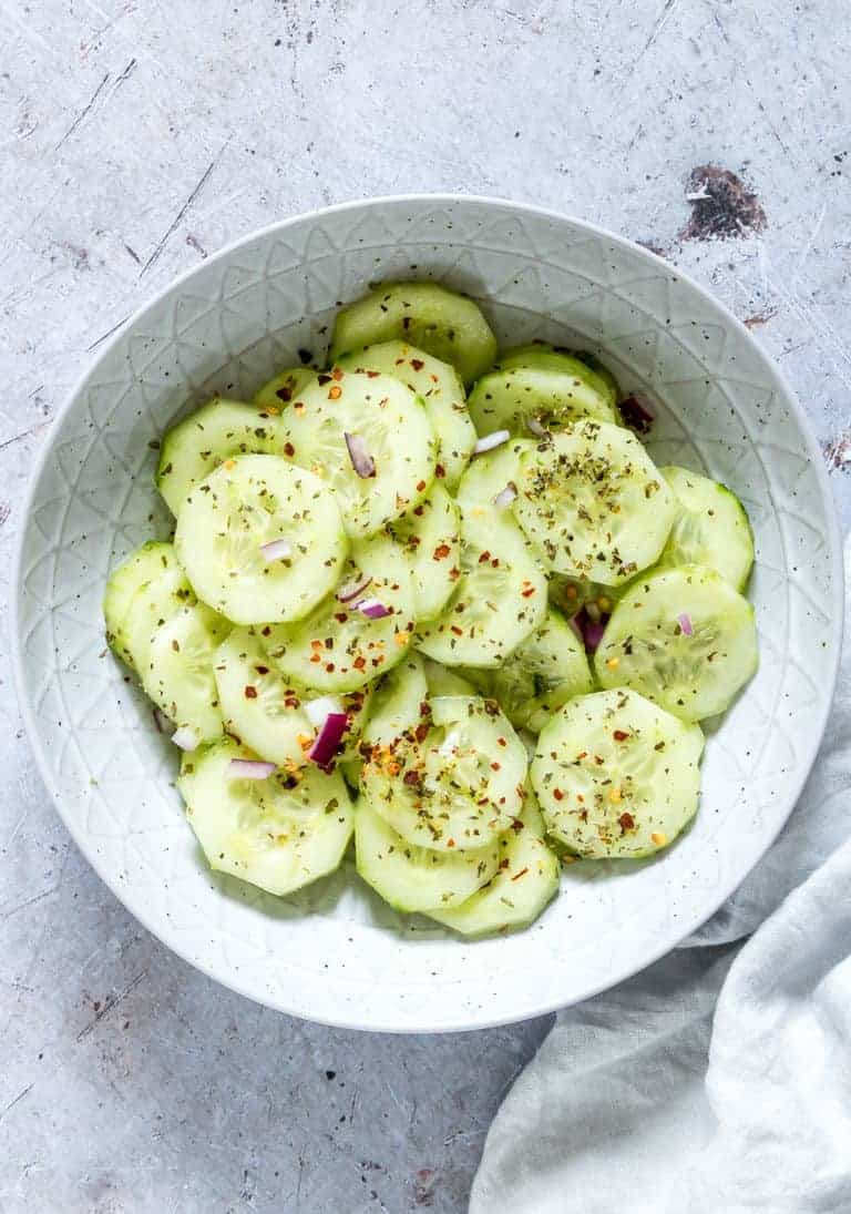 close up of cucumber salad with onion and chili