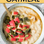 Oatmeal in a bowl with a spoon, garnished with apples and pumpkin seeds