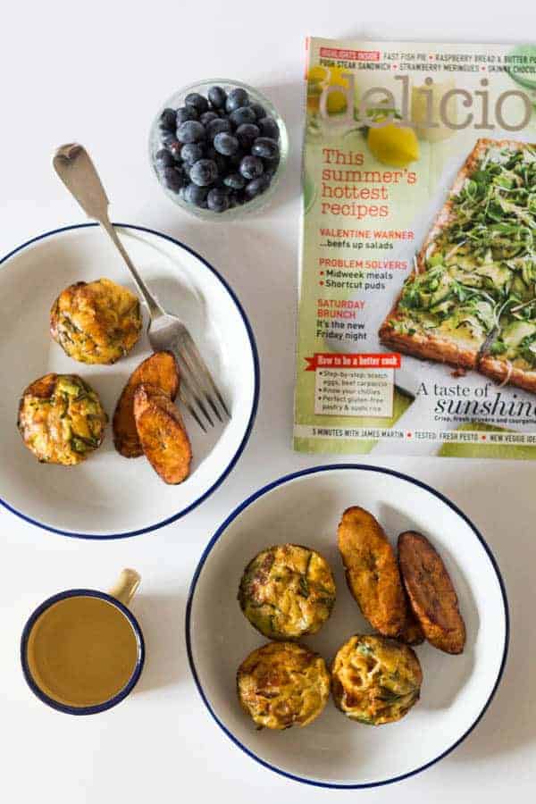 overhead view of a plantain frittata in a bowl next to a spoon and a magazine