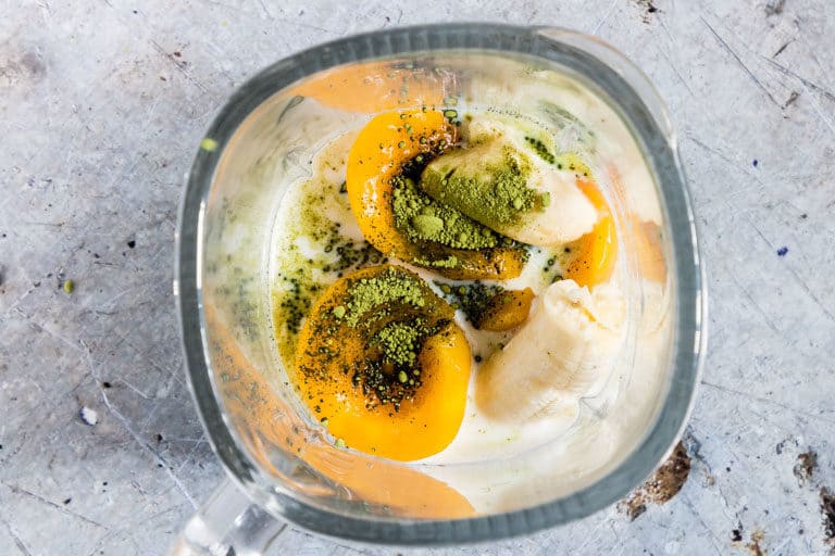 Matcha Smoothie (green Tea Smoothie) in a blender - peaches, milk, matcha, banana