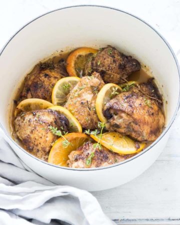 close up of lemon and garlic crockpot chicken thighs garnished with citrus spices
