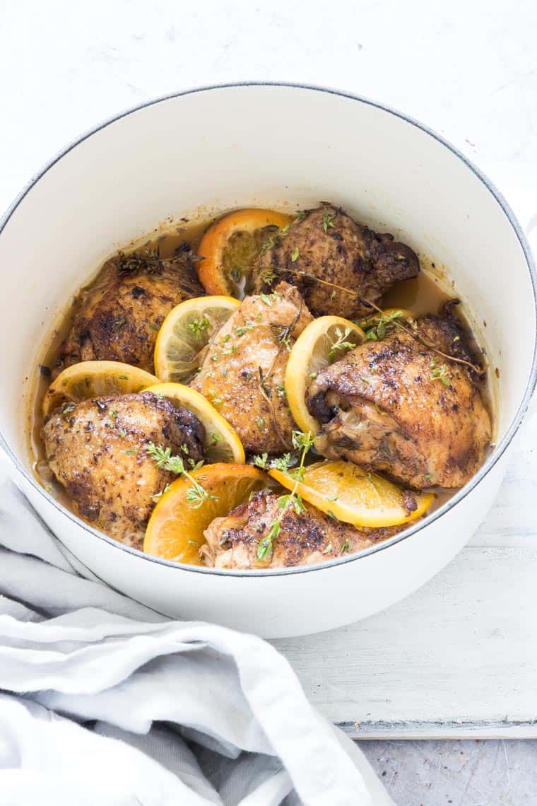 close up of lemon and garlic crockpot chicken thighs garnished with citrus spices