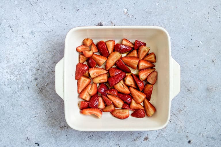 balsamic strawberries in a tray ready for baking