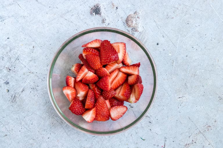 a bowl of sliced strawberries