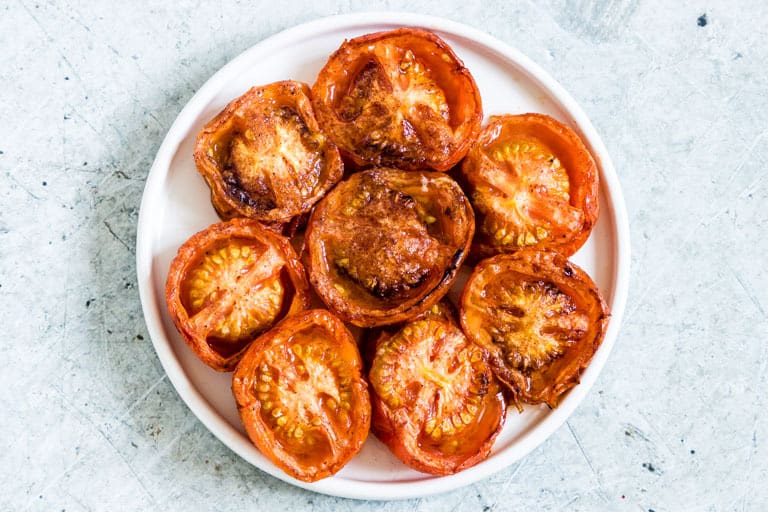 landscape image of baked tomatoes with all spice and cinnamon
