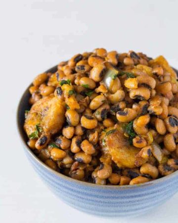 blue bowl containing beans and plantains