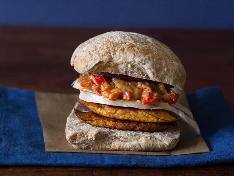 closeup of Chicken Plantain Sandwich against a blue and black background