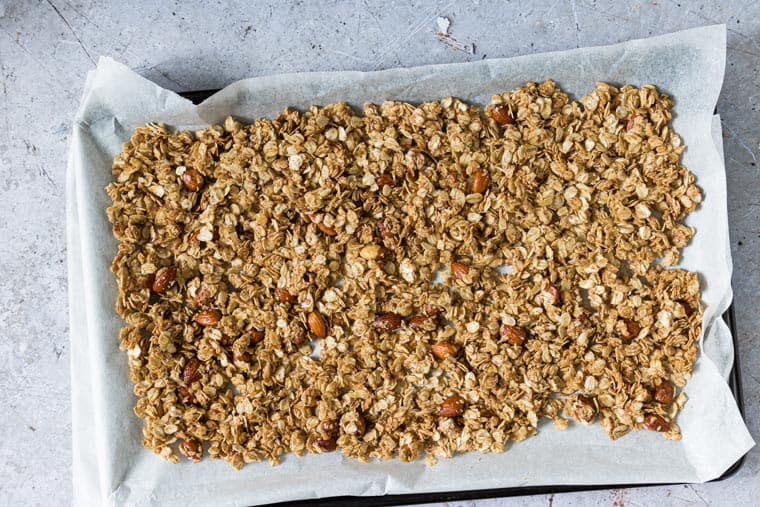 almond butter granola on a tray for baking