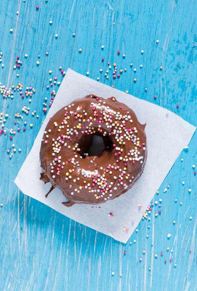 overhead view of nutella donut on a white napkin on a blue background