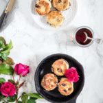 singin hinnes singing hinnies on a plate and cast iron pot with syrup and flowers on a table. | Recipes From A Pantry