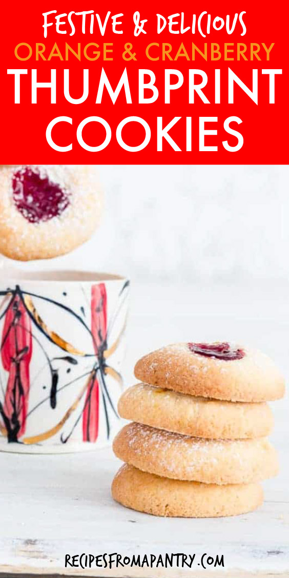 A stack of four thumbprint cookies with a mug in the background
