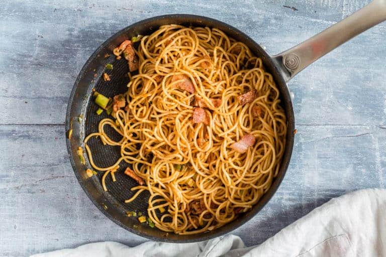 A pot with some harissa bacon garlic pasta recipe on a table