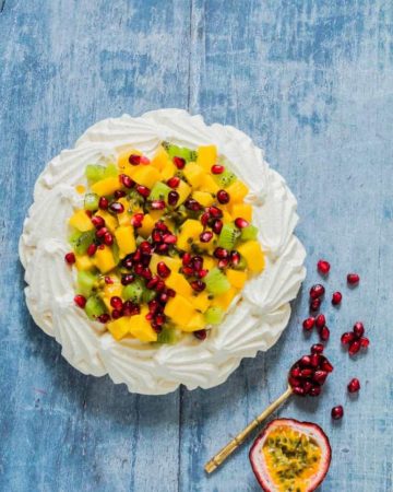 This kiwi mango pavlova with coconut whipped cream is an easy dessert recipe that takes 10 mins to make and guaranteed crowd pleaser. recipesfromapantry.com.