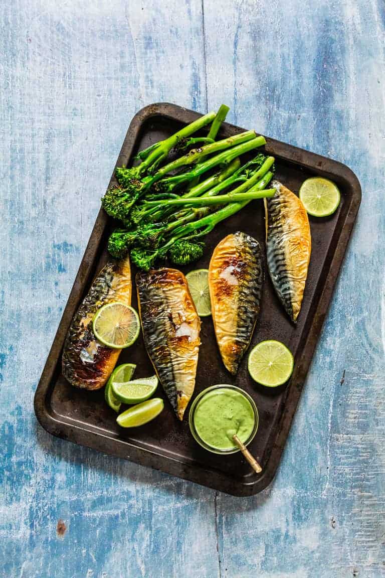 grilled mackerel fillets with a green goddess dressing and grilled broccoli on a tray