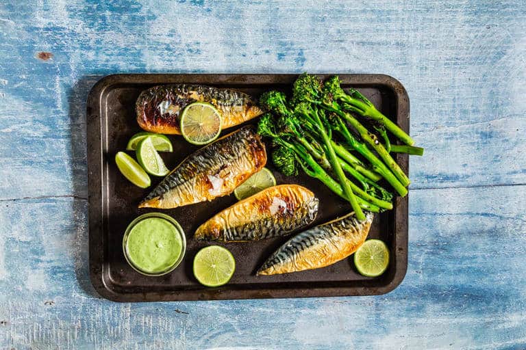 These grilled mackerel fillets with vegetables, limes and green goddess dressing on a tray