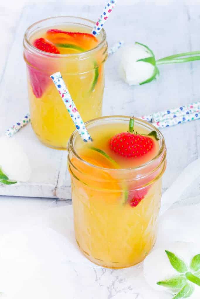 2 Pineapple daiquiri cocktails on a table with straws and flowers. recipesfromapantry.com