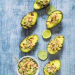 This grilled avocado stuffed with veggie quinoa is a fun veggie BBQ recipe. This is vegan and gluten-free too. Recipesfromapantry.com