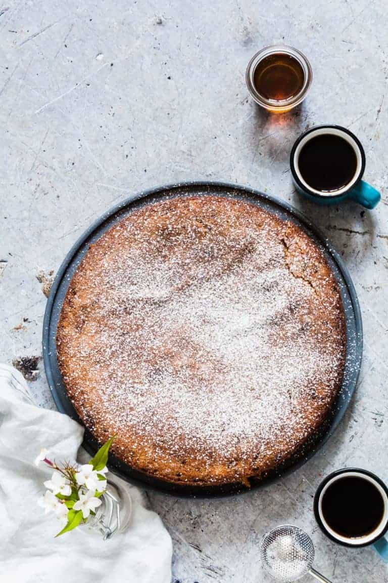 A courgette cake with coffee and syrup on a table