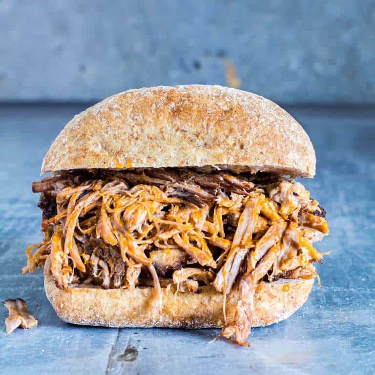 This Dutch Oven Pulled Pork sandwich, on a table. 