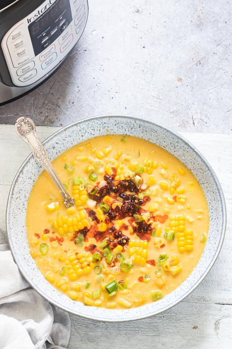 a bowl of sweet potato chowder next to the instant pot