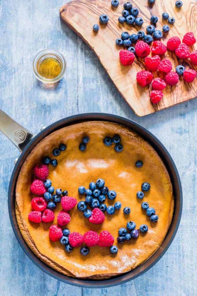 This easy 7-ingredient baked pumpkin pancake with berries is mixed in a blender. It is made with pantry staples & warming spices - recipesfromapantry.com #bakedpumpkinpancake #pumpkinpancake #bakedpancake