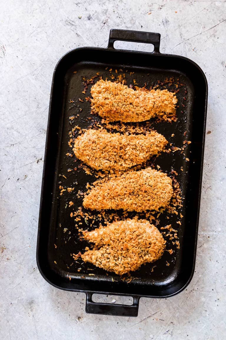 Top down view of parmesan crusted chicken tenders in a pan