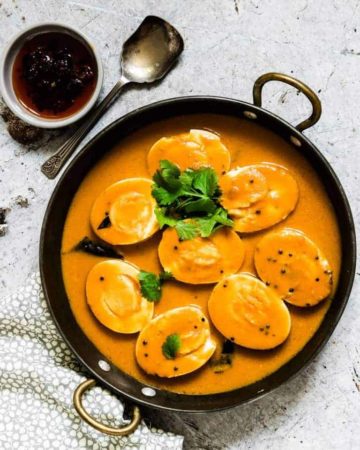 An easy creamy Indian egg curry recipe which is eggs cooked in an aromatic tomato sauce and is suitable for vegetarians. #easyeggcurry #eggcurry #eggcurryrecipe #indianeggcurry #goaneggcurry