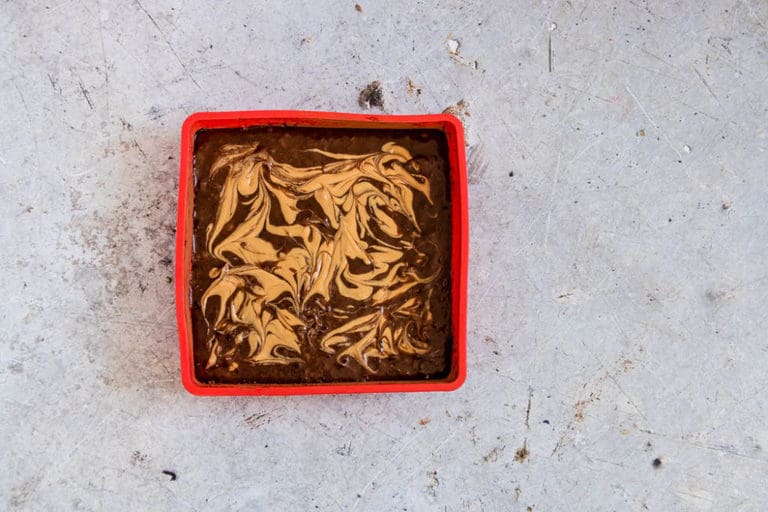 Banana brownies (vegan brownies) batter with a peanut butter swirl in a baking try