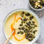 Instant Pot Potato Soup in four bowls, with pumpkin seeds and chilli oil with a spoon