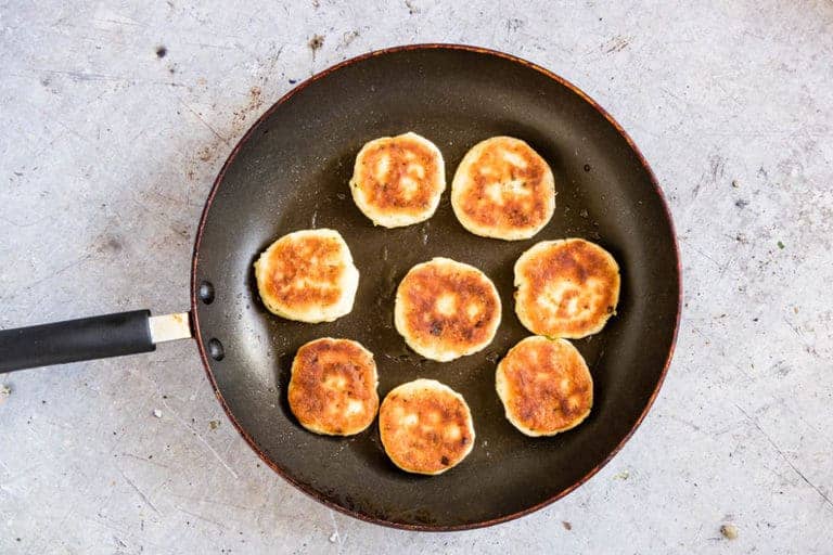 8 Potato Pancakes with Leftover Mashed Potatoes in a frying pan