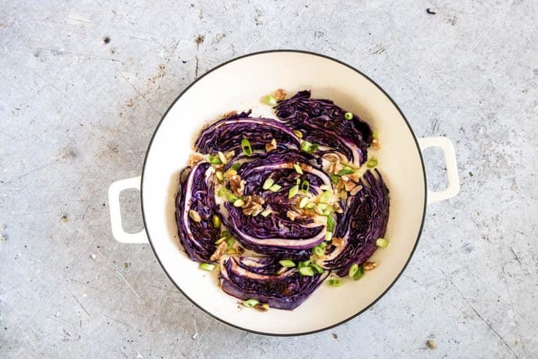 Baharat spiced Roasted red cabbage in a pot with walnuts, spring onions, 