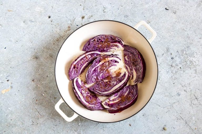 red cabbage wedges in a pot with baharat and oil