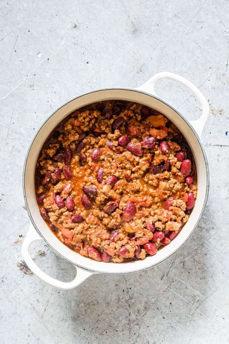 Instant Pot Chili in a white pot on a grey background 