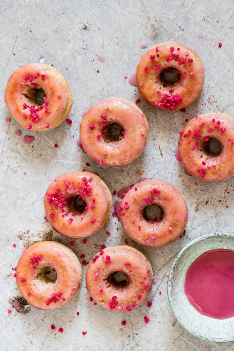 Overhead shot of glazed donuts with freeze dried raspberries close up