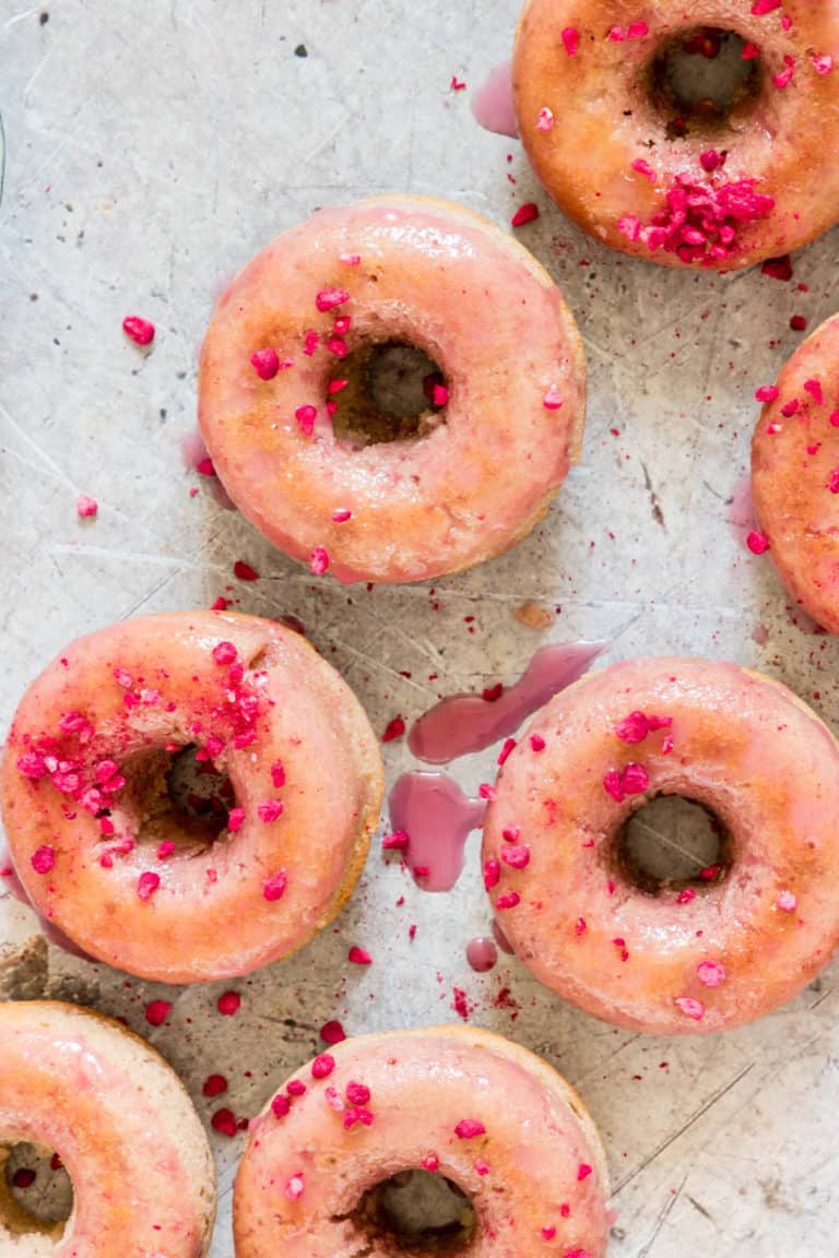 Overhead shot of glazed donuts with freeze dried raspberries