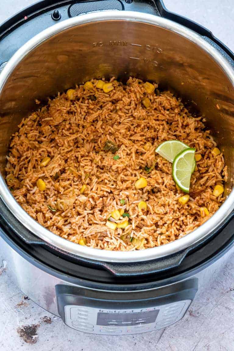 close up image of instant pot mexican rice in an Instant Pot garnished with greens